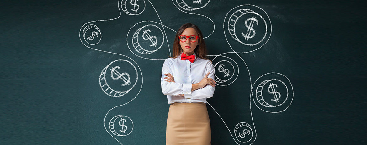 Young girl standing in front of blackboard with dollar signs