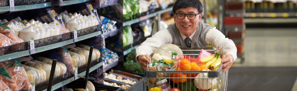 Man behind trolley in supermarket