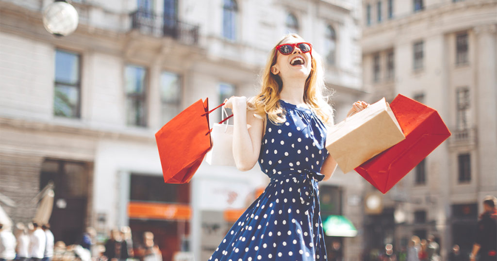 Lady in square holding shopping bags