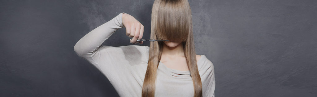 Female cutting her fringe