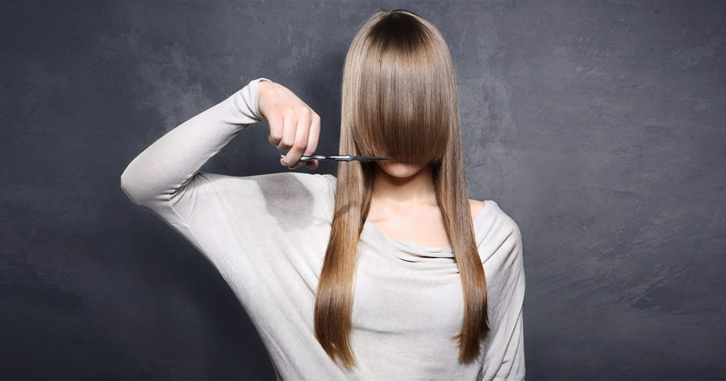 Female cutting her fringe