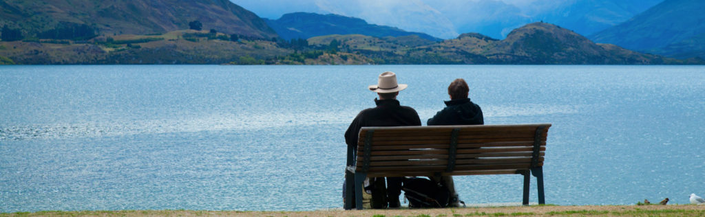 Retired couple sitting on chair looking out at Lake Wanaka